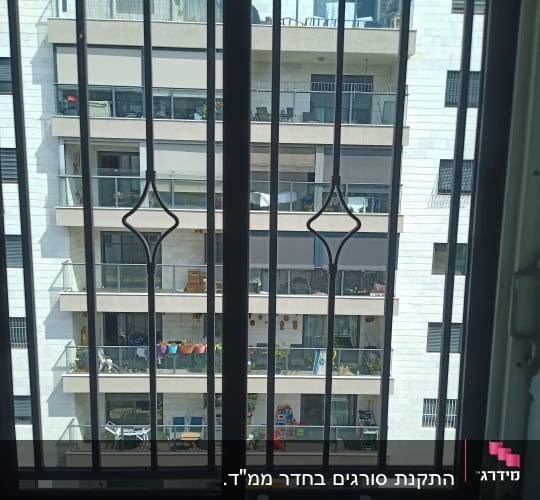 סורגים שחורים על רקע בניין מגורים